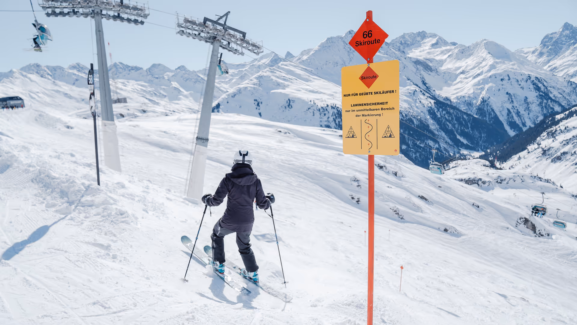 Ski route board with additional danger warning sign at Ski Arlberg, St. Anton
